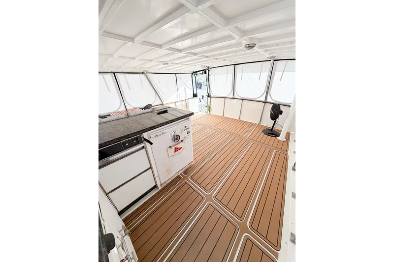 Slide: The Image of 1989 Jefferson Marquessa 52 yacht interior with wood flooring and kitchen area. - 25