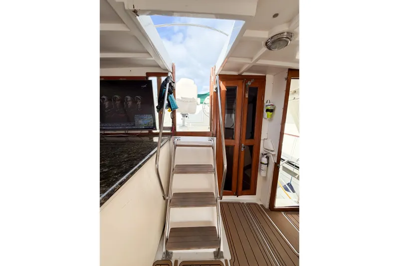 Slide: The Image of Interior view of 1989 Jefferson Marquessa 52 yacht with wooden doors and stairs. - 28