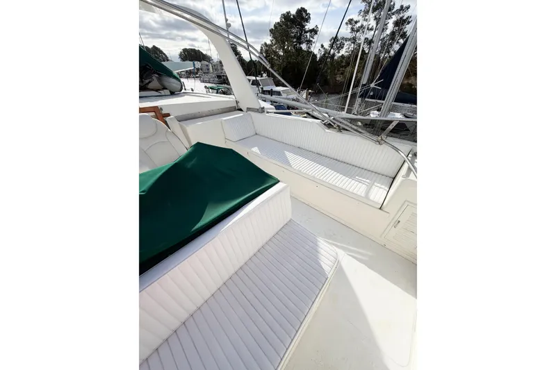 Slide: The Image of 1989 Jefferson Marquessa 52 Extended Deckhouse yacht with white seating and green cover. - 31
