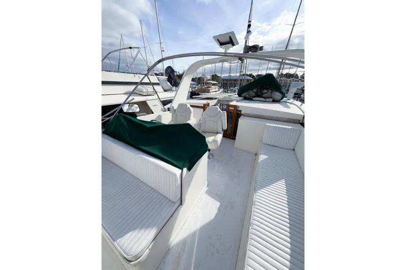 Slide: The Image of 1989 Jefferson Marquessa 52 yacht deck with white seating and green covers. - 33