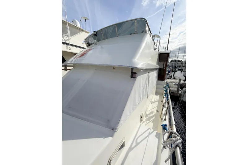 Slide: The Image of 1989 Jefferson Marquessa 52 Extended Deckhouse yacht docked at marina. - 41