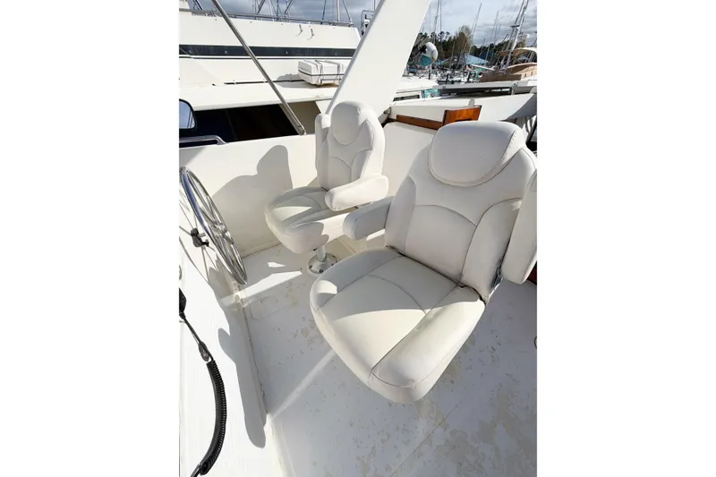 Slide: The Image of Captain's chairs on 1989 Jefferson Marquessa 52 yacht deck, featuring sleek white upholstery. - 43