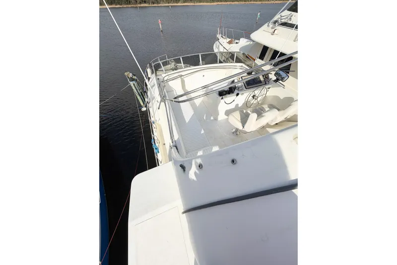 Slide: The Image of 1989 Jefferson Marquessa 52 yacht deck view, featuring helm and seating area. - 48