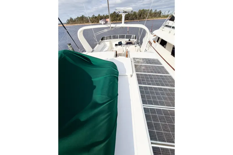 Slide: The Image of 1989 Jefferson Marquessa 52 yacht deck with solar panels and green cover. - 49