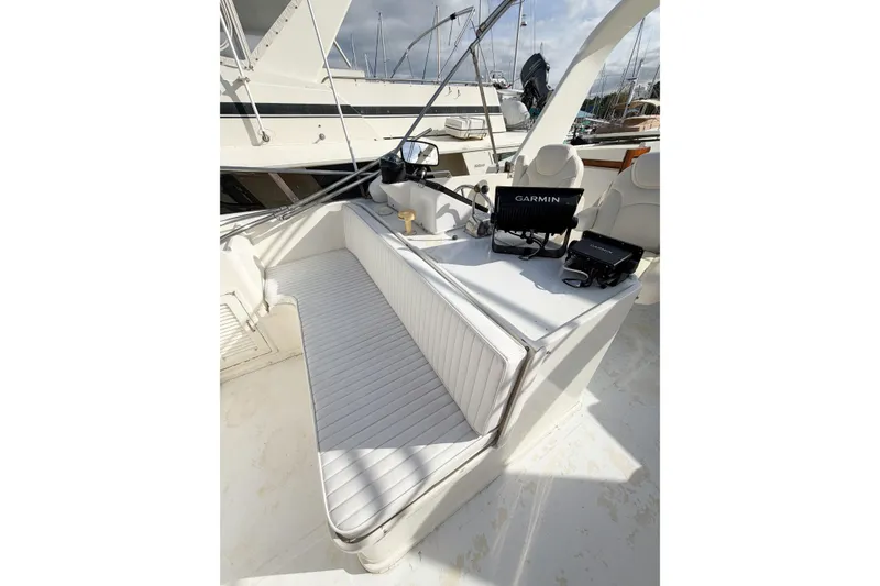 Slide: The Image of 1989 Jefferson Marquessa 52 yacht deck with seating and Garmin navigation equipment. - 50