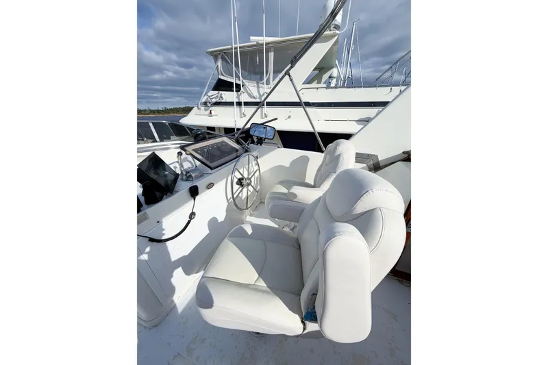 Slide: The Image of Captain's helm of 1989 Jefferson Marquessa 52 yacht with white seating and steering wheel. - 51