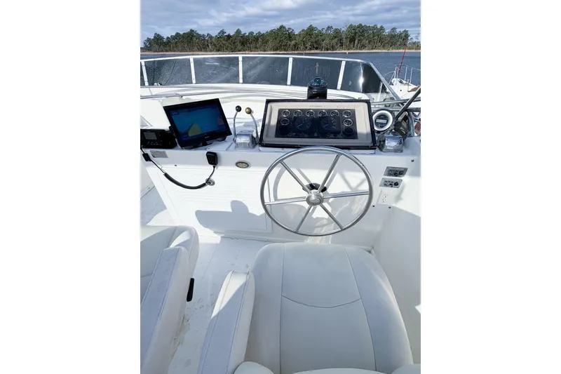 Slide: The Image of 1989 Jefferson Marquessa 52 yacht helm with steering wheel and navigation equipment. - 52