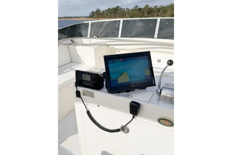 Slide: The Image of Helm of 1989 Jefferson Marquessa 52 with navigation equipment and serene water view. - 54