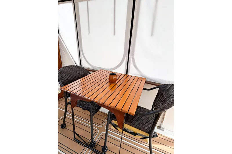 Slide: The Image of Wooden table and chairs on Jefferson Marquessa 52 yacht deck, 1989 model. - 55