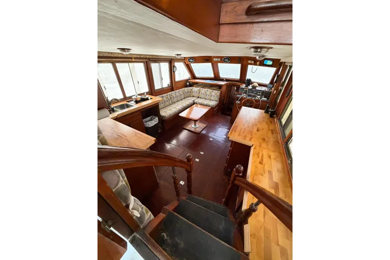 Slide: The Image of Interior of 1989 Jefferson Marquessa 52 yacht with wood finishes and seating area. - 56