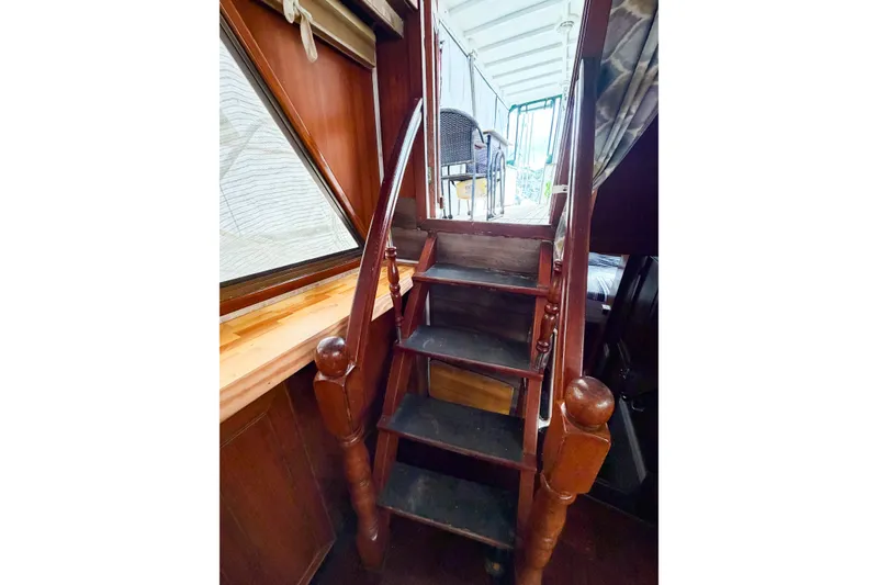 Slide: The Image of Wooden staircase inside 1989 Jefferson Marquessa 52 Extended Deckhouse yacht, leading to upper deck. - 57