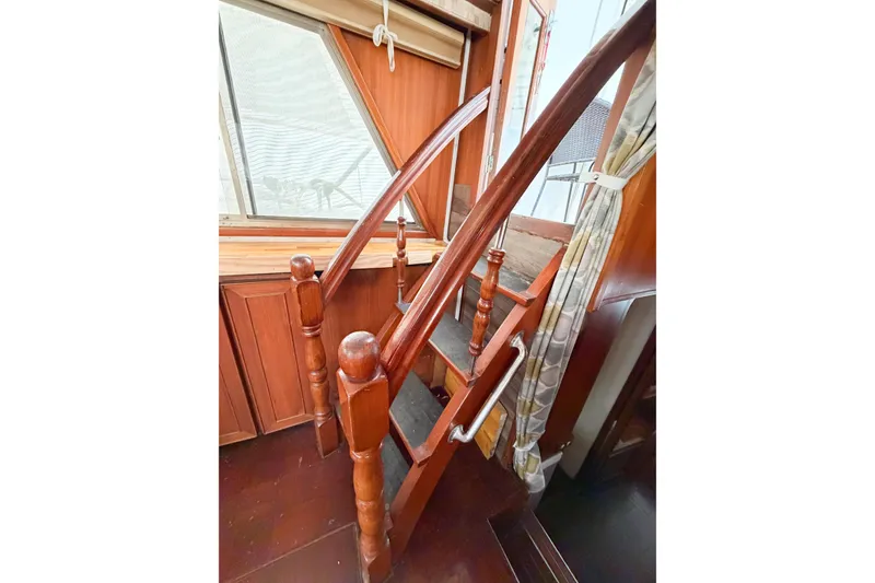 Slide: The Image of Wooden staircase inside 1989 Jefferson Marquessa 52 Extended Deckhouse yacht, featuring polished handrails. - 58