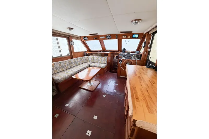 Slide: The Image of Interior of 1989 Jefferson Marquessa 52 yacht with wood finish and spacious seating area. - 59