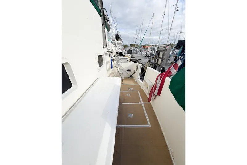 Slide: The Image of 1989 Jefferson Marquessa 52 yacht deck with American flag, docked at marina. - 6