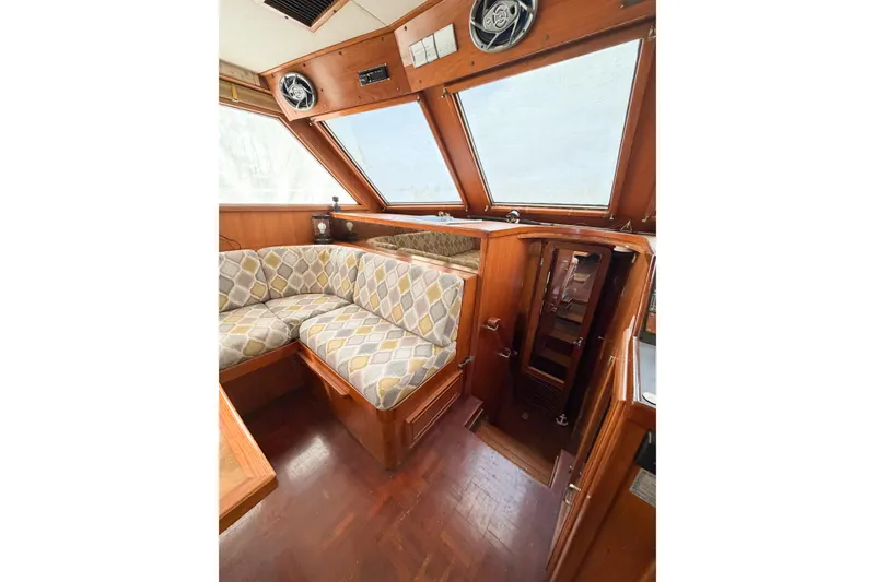 Slide: The Image of Interior of 1989 Jefferson Marquessa 52 yacht with wood paneling and patterned seating. - 61