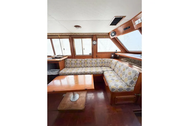 Slide: The Image of Interior of 1989 Jefferson Marquessa 52 yacht with patterned seating and wooden table. - 62