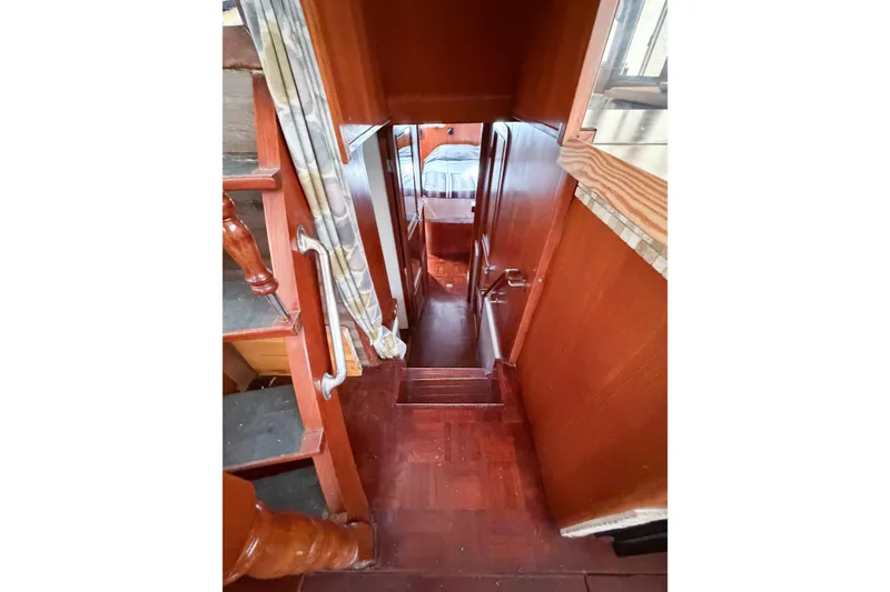 Slide: The Image of Interior view of 1989 Jefferson Marquessa 52 yacht, featuring wooden stairs and cozy cabin. - 65