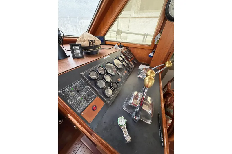 Slide: The Image of Control panel of 1989 Jefferson Marquessa 52 yacht with gauges, levers, and nautical decor. - 67