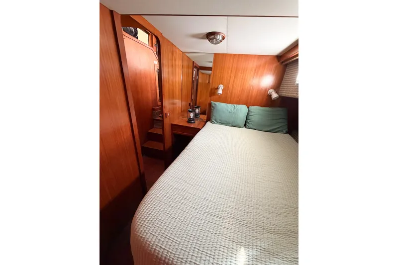 Slide: The Image of Cozy bedroom interior of 1989 Jefferson Marquessa 52 yacht with wood paneling and soft lighting. - 71