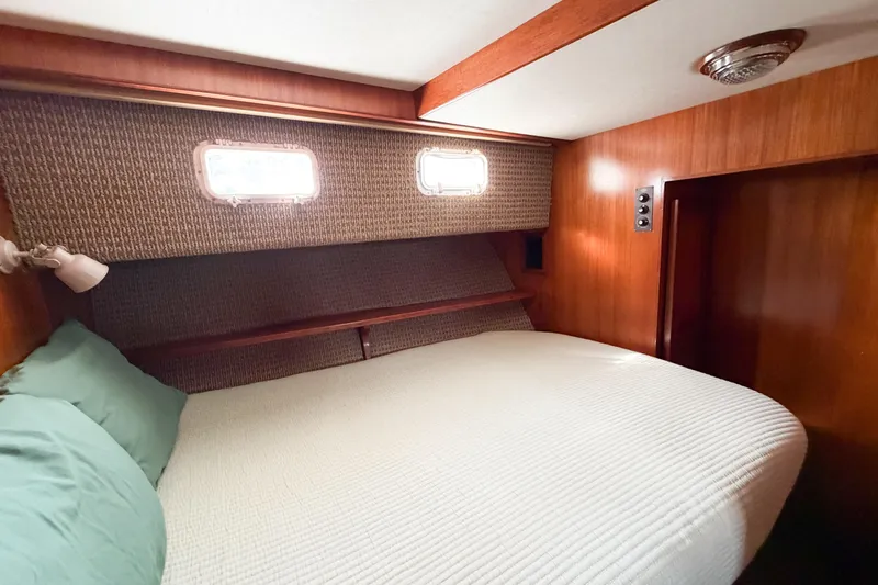 Slide: The Image of Cozy bedroom in 1989 Jefferson Marquessa 52 yacht with wood paneling and porthole windows. - 76