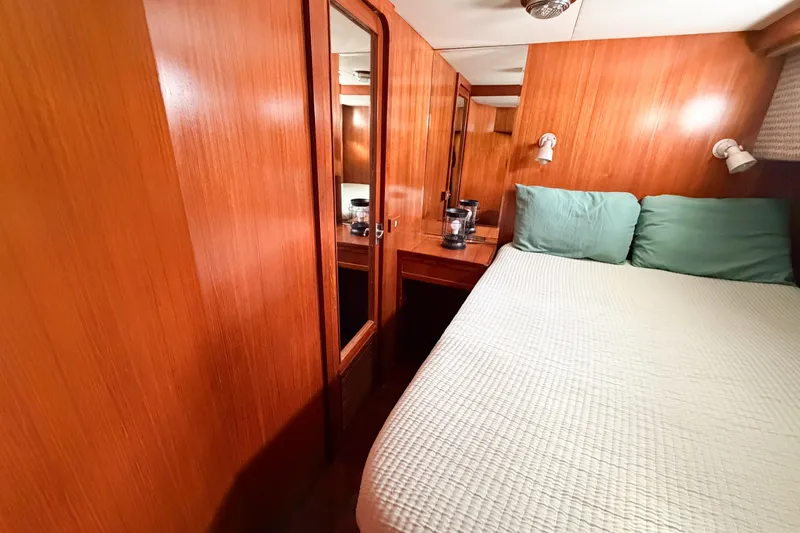 Slide: The Image of Cozy cabin interior of 1989 Jefferson Marquessa 52 yacht with wood paneling and bed. - 77