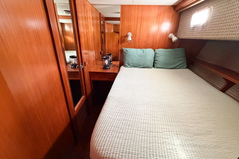 Slide: The Image of Cozy bedroom in 1989 Jefferson Marquessa 52 yacht with wood paneling and soft lighting. - 78