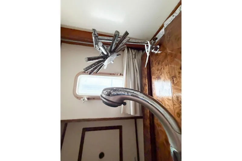 Slide: The Image of Interior of 1989 Jefferson Marquessa 52 yacht, featuring a unique faucet and window. - 86