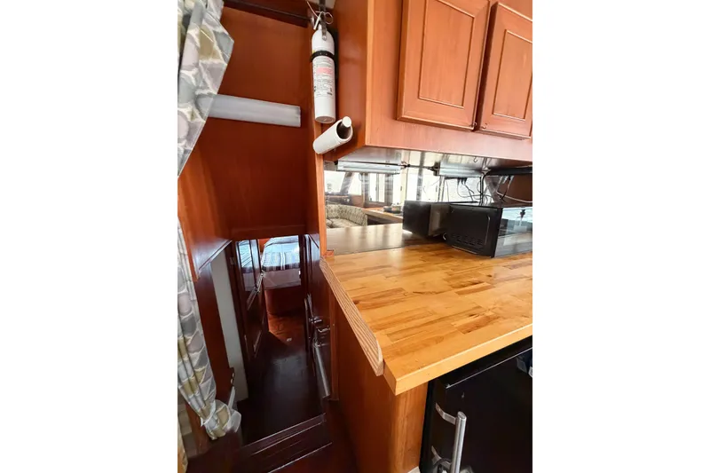 Slide: The Image of 1989 Jefferson Marquessa 52 yacht interior with wooden cabinetry and countertop. - 89