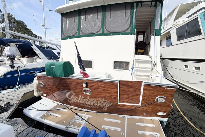 Slide: The Image of 1989 Jefferson Marquessa 52 yacht docked, featuring "Solidarity" nameplate and American flag. - 9