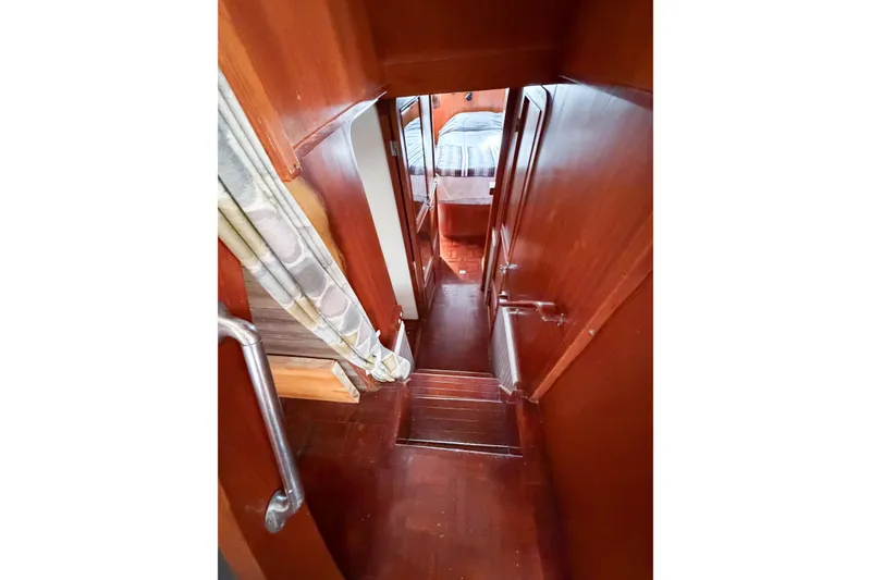 Slide: The Image of Interior hallway of 1989 Jefferson Marquessa 52 Extended Deckhouse yacht, featuring wood paneling. - 90