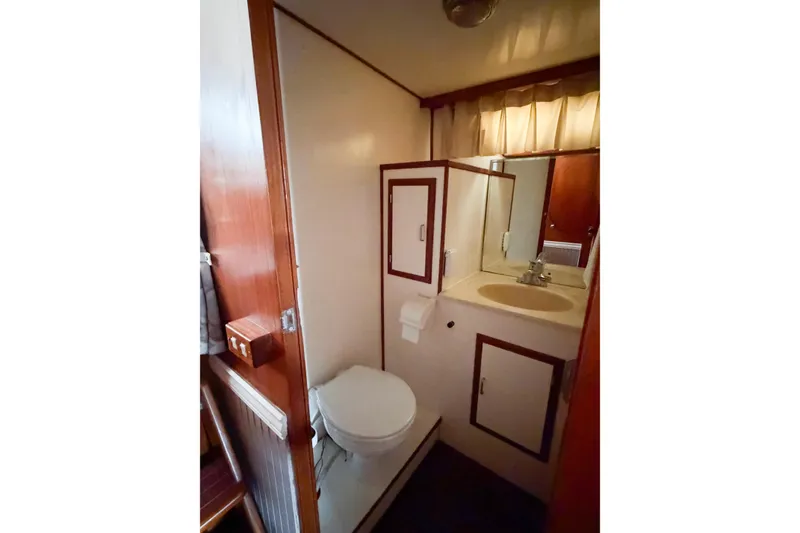 Slide: The Image of Bathroom interior of 1989 Jefferson Marquessa 52 Extended Deckhouse yacht, featuring sink and toilet. - 91
