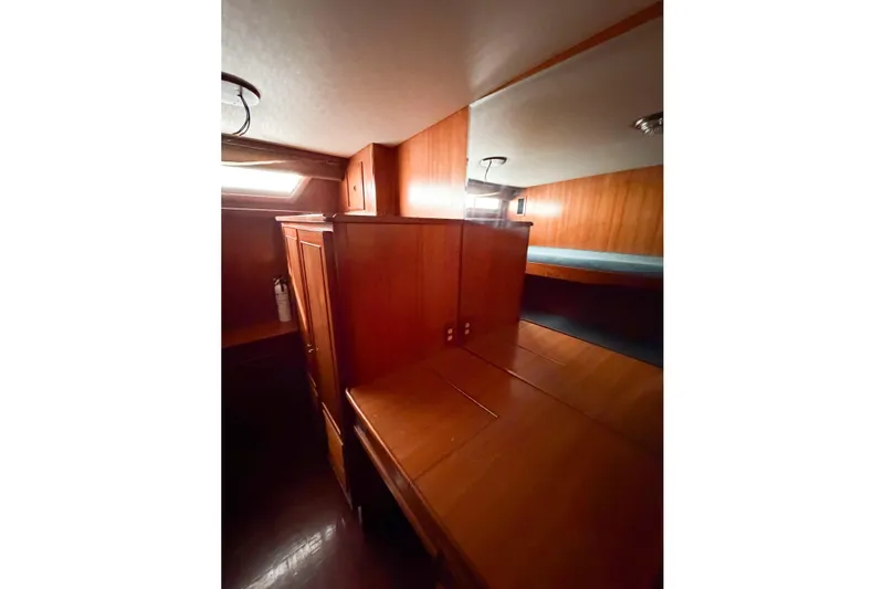 Slide: The Image of Interior of 1989 Jefferson Marquessa 52 yacht with wooden cabinetry and cozy lighting. - 95