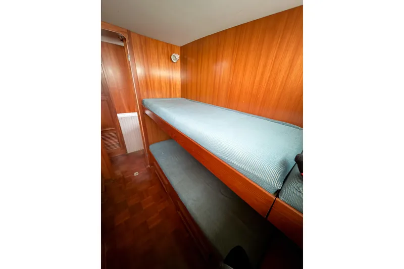 Slide: The Image of Interior of 1989 Jefferson Marquessa 52 yacht with wooden bunk beds and cozy cabin. - 98