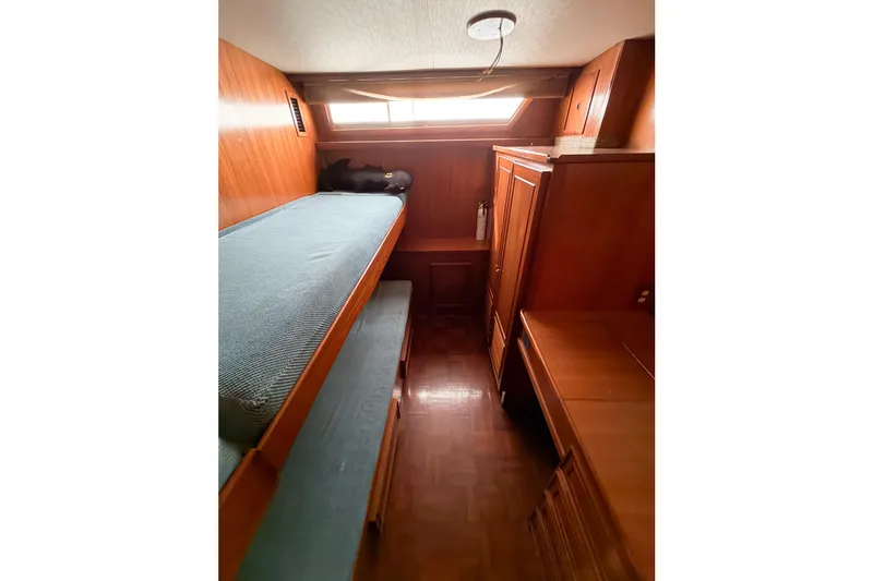 Slide: The Image of Interior cabin of 1989 Jefferson Marquessa 52 yacht with wooden furnishings and bunk beds. - 99