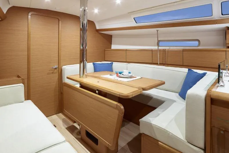 Slide: The Image of Manufacturer Provided Image: Interior of 2019 Jeanneau Sun Odyssey 389 sailboat with modern wood finish and cozy seating. - 2