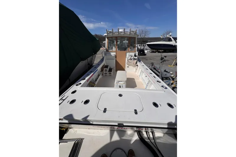 Slide: The Image of 2021 Steiger Craft 25 Chesapeake boat, open deck view, parked outdoors under clear sky. - 14