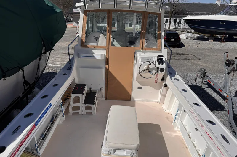 Slide: The Image of 2021 Steiger Craft 25 Chesapeake boat interior with helm and seating area. - 16
