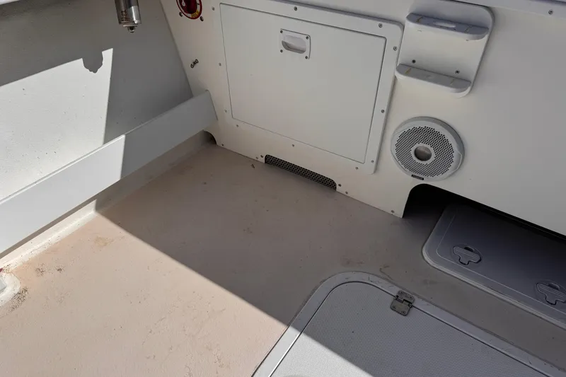 Slide: The Image of Interior view of a 2021 Steiger Craft 25 Chesapeake boat, featuring storage and speaker. - 19
