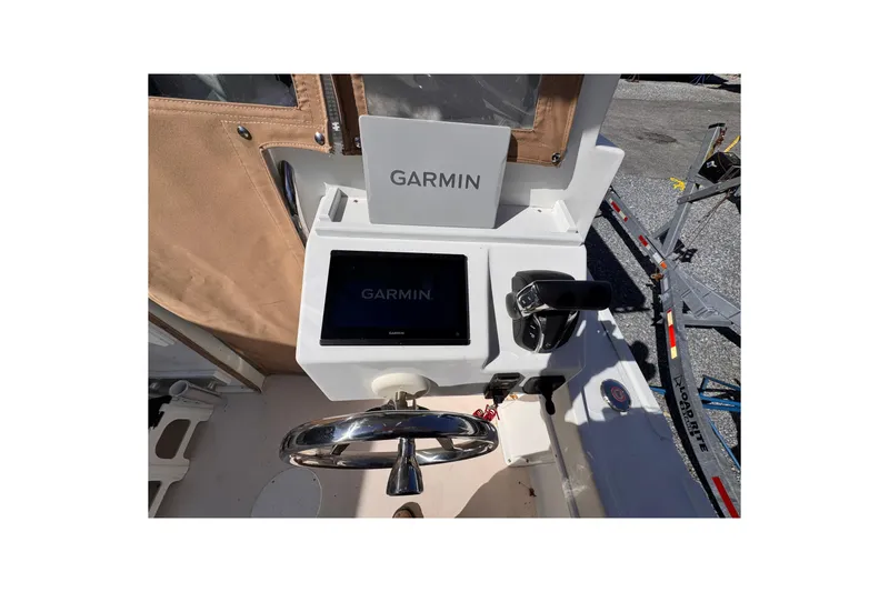 Slide: The Image of Steiger Craft 25 Chesapeake 2021 helm with Garmin navigation system and steering wheel. - 25