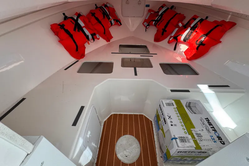 Slide: The Image of Interior of 2021 Steiger Craft 25 Chesapeake boat with life jackets and storage. - 26