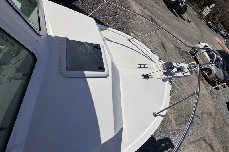 Slide: The Image of 2021 Steiger Craft 25 Chesapeake boat deck with hatch and railing in a parking area. - 27