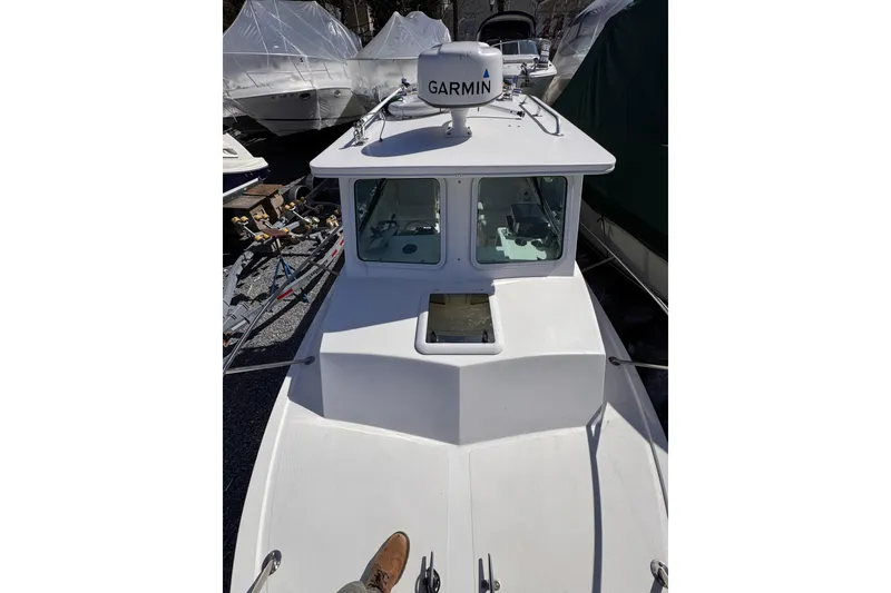 Slide: The Image of 2021 Steiger Craft 25 Chesapeake boat with Garmin radar, docked outdoors. - 28