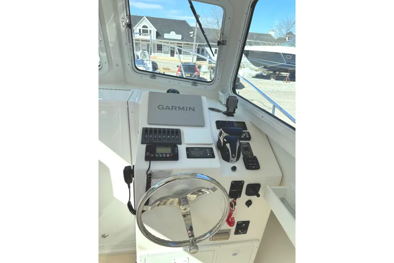 Slide: The Image of 2021 Steiger Craft 25 Chesapeake helm with Garmin navigation system and controls. - 6