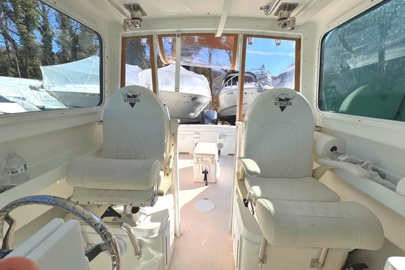 Slide: The Image of Interior of 2021 Steiger Craft 25 Chesapeake boat with two white captain chairs. - 7