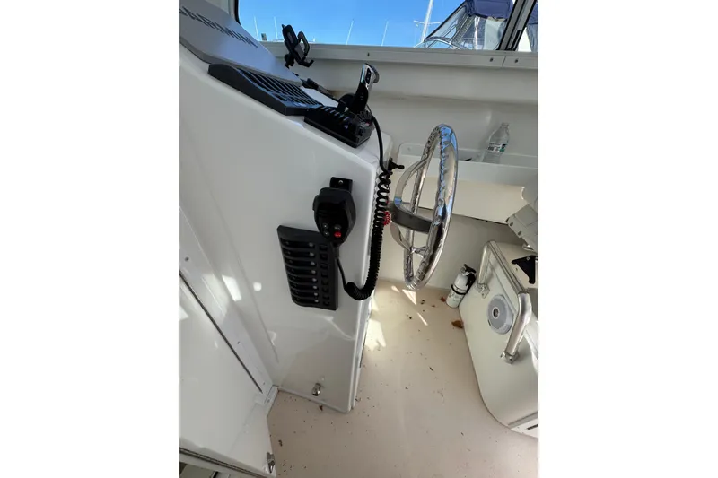 Slide: The Image of Interior view of 2021 Steiger Craft 25 Chesapeake boat helm with steering wheel and controls. - 8