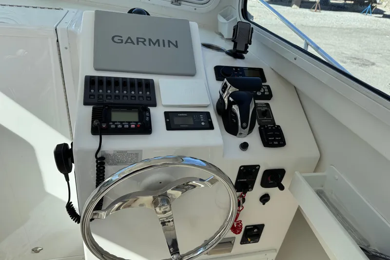 Slide: The Image of Steiger Craft 25 Chesapeake 2021 helm with Garmin navigation and control panel. - 9