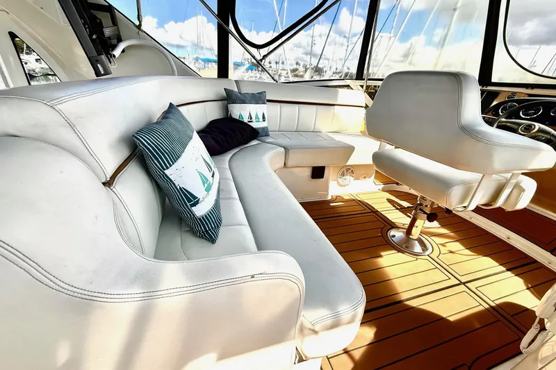 Slide: The Image of Luxurious interior of 2001 Carver 444 Cockpit Motor Yacht with plush seating and nautical decor. - 11