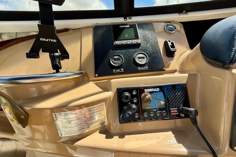 Slide: The Image of 2001 Carver 444 Cockpit Motor Yacht dashboard with all new Simrad navigation and electronics equipment. - 14