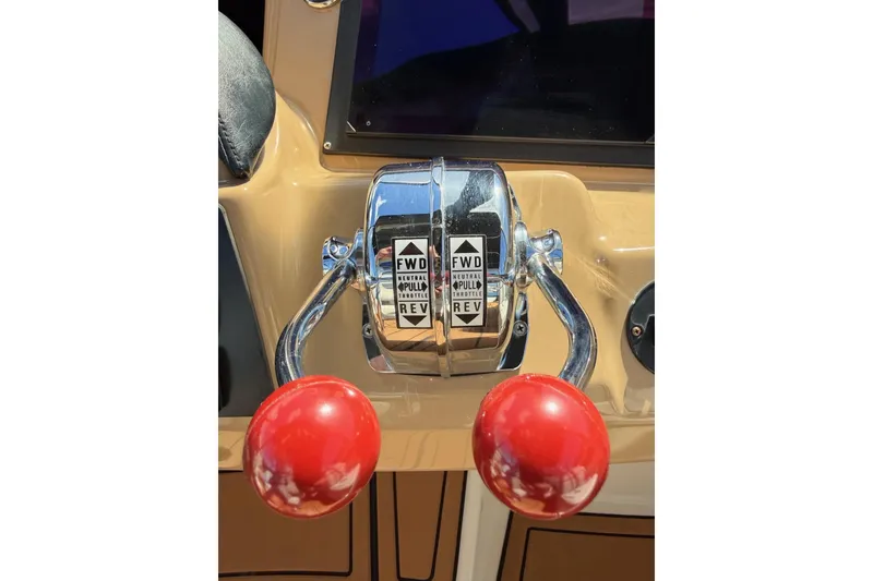Slide: The Image of Throttle controls of a 2001 Carver 444 Cockpit Motor Yacht with red handles. - 16