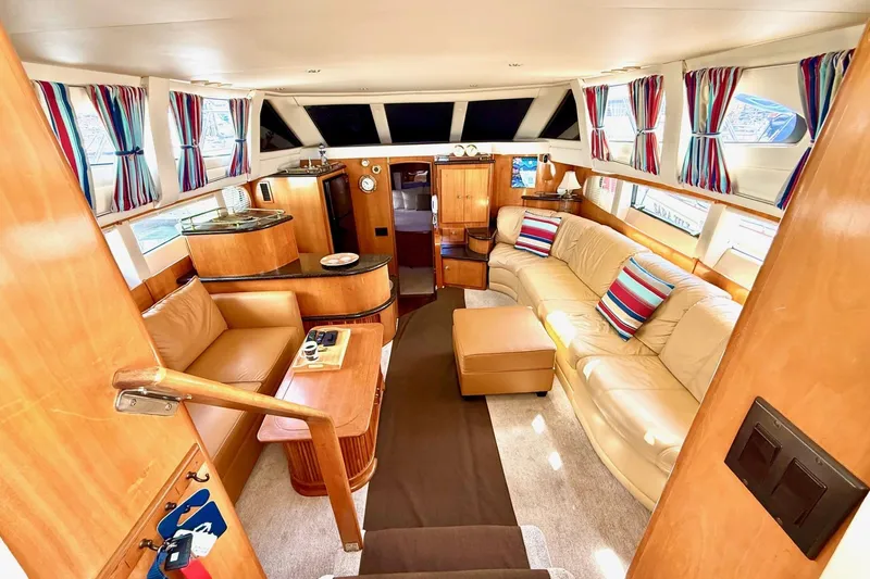 Slide: The Image of Luxurious interior of 2001 Carver 444 Cockpit Motor Yacht with plush seating and vibrant decor. - 22